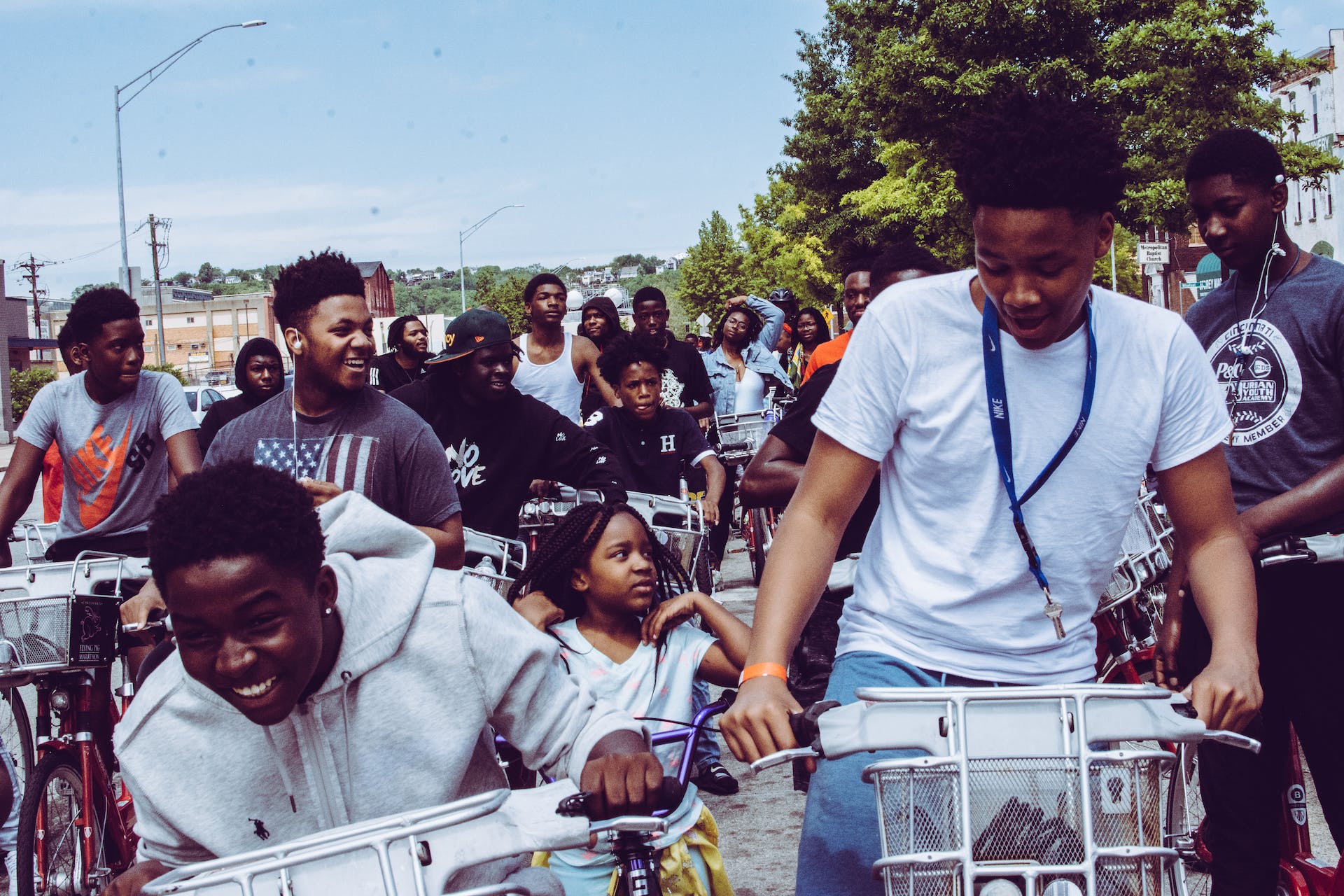 Group of black children riding bikes down a street